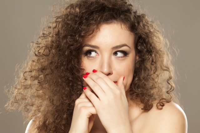 portrait of a young woman checking her breath